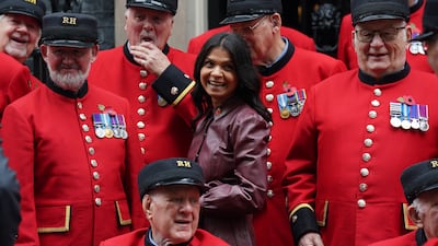 Akshata Murty, wife of Prime Minister Rishi Sunak, poses with a group of Chelsea Pensioners in Downing Street, London. PA