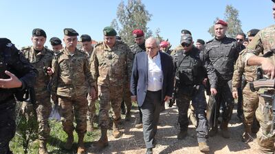 Lebanese Prime Minister Nawaf Salam and acting army chief Maj Gen Hassan Audi, third from left, during a visit to the southern town of Khiam. EPA