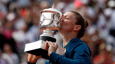 Simona Halep poses with the trophy after winning the French Open final against Sloane Stephens. EPA