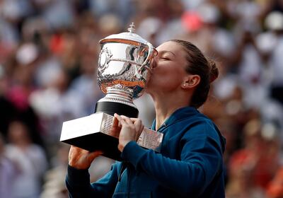 Simona Halep poses with the trophy after winning the French Open final against Sloane Stephens. EPA