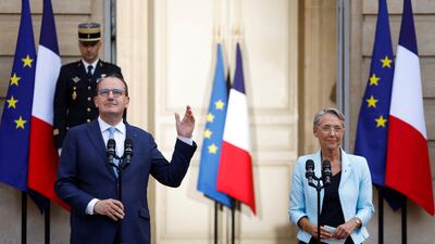 Mr Castex gestures next to Ms Borne. Reuters