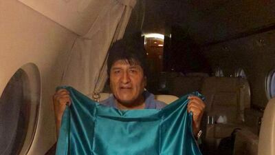 Former Bolivian President Evo Morales holds a Mexican flag onboard a Mexican government jet on November 11, 2019. Twitter