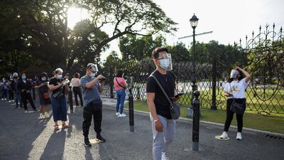 People wearing face masks and face shields as protection from the coronavirus disease (COVID-19) queue outside a newly reopened historical site, in Manila, Philippines. Reuters