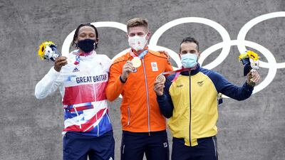 Great Britain's Kye Whyte receives his silver medal alongside Netherlands' Niek Kimmann (gold) and Colombia's Carlos Ramirez (bronze) in the Cycling BMX Racing at the Ariake Urban Sports Park.