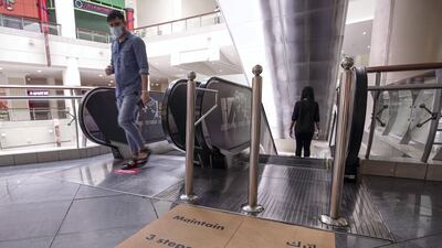A safe distance sign on the escalator at Abu Dhabi's Al Wahda Mall. Victor Besa / The National