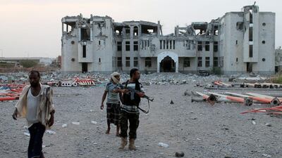Southern Resistance fighters walk in the Dar Saad suburb in the north of the southern embattled Yemeni city of Aden on July 29. AFP Photo