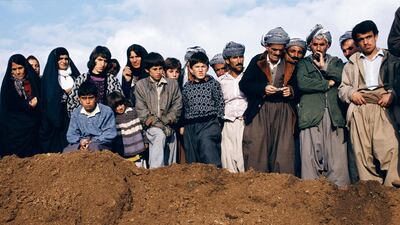 A photograph by Meiselas shows the mass grave of the friends and family of those pictured being exhumed. Susan Meiselas / Magnum