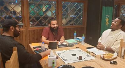 Abdullah El Omari, centre, running a game of Dungeons and Dragons with his friends. Photo: Abdullah El Omari