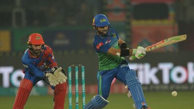Multan Sultans' captain Mohammad Rizwan (R) plays a shot as Karachi Kings' wicketeeper Matthew Wade watches during the Pakistan Super League (PSL) T20 cricket match between Karachi Kings and Multan Sultans at the Multan Cricket Stadium in Multan on February 22, 2023. (Photo by Shahid Saeed MIRZA / AFP)