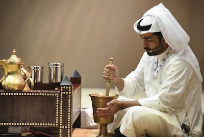 The first contestant in the medium / dark roast category, Zayed Al Tamimi, grinds his coffee beans at the first ever Gahwa Championship. Khushnum Bhandari for The National