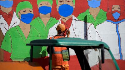 A city worker draws a mural campaigning against the Covid-19 on a wall in Jakarta. Indonesia had reported over 150,000 coronavirus cases and 6,858 deaths, but with some of the world's lowest testing rates the true scale is widely believed to be much greater. AFP
