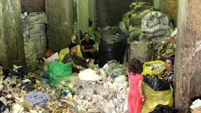 A Coptic Christian family sorts through rubbish in the Cairo slum of Manshiyat Naser. Sandor Jaszberenyi for The National / May 14, 2014