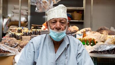 A vendor wearing a face mask against the coronavirus sits in front of his shop at the Mutrah Souq in the Omani capital Muscat. AFP