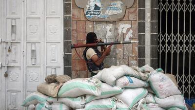 An Armed Yemeni tribal gunman from the Popular Resistance Committees loyal to Yemen's fugitive president Abdrabu Mansur Hadi, monitors a street in the southern city of Taez during ongoing clashes with Shiite Houthi rebels.Abdul Rahman Alballah/ AFP Photo