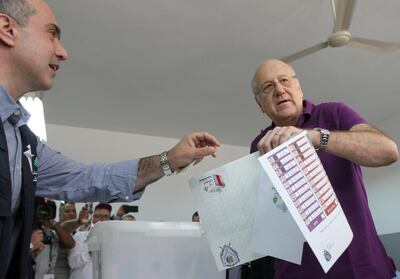 Lebanon's former Prime Minister and a candidate for the parliamentary election Najib Mikati, holds his ballot at a polling station in Tripoli, northern Lebanon, on May 6, 2018. Omar Ibrahim / Reuters