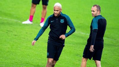 Barcelona players Neymar, left, and Andres Iniesta, right, perform during their team’s training session. Marius Becker / EPA