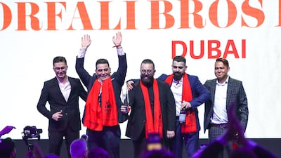 From left, the Orfali brothers Wassim, Mohammad and Omar don scarves after their win. Photo: Victor Besa / The National