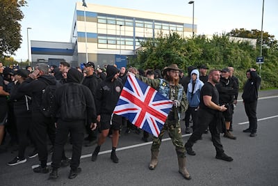 Supporters of anti-migrant activist Daniel Thomas gather outside Basingstoke police station. Getty