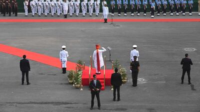 Mr. Modi salutes a guard of honour. AFP
