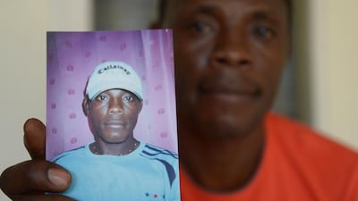 Beliby Ferdinand Bengondo holding a picture of his late brother, Salomon Bengondo. Cameroonian striker Salomon Bengondo arrived in Indonesia in 2005, a promising young footballer who hoped to build a career in Southeast Asia's biggest nation. But instead of sporting glory, his story ended in tragedy. Adek Berry / AFP