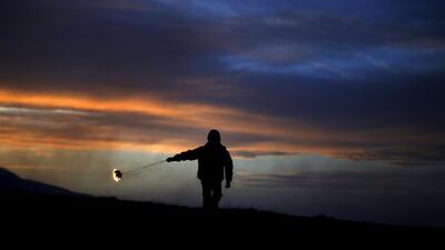 A boy spins a ring of fire during rituals in celebration of Mesni Zagovezni, the second Sunday before Great Lent, in the village of Lozen, Bulgaria. Stoyan Nenov / Reuters
