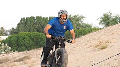 Fahad Hareb hits the sand on his Saluki electric motorcycle in Al Khawaneej, Dubai. Jeff Topping for The National