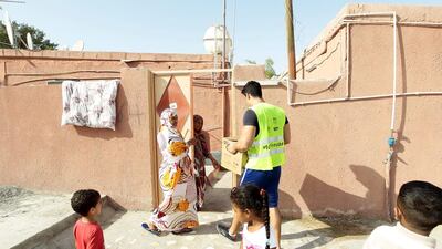 Khalifa Bin Hendi and his team of volunteers fan out to distribute food and household supplies pack in cartoons, for 300 homes in the Al Quoz neighbourhood. Jeffrey E. Biteng / The National