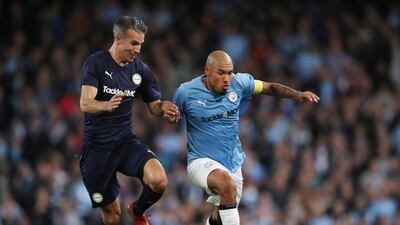 Manchester City Legends' Nigel de Jong in action with Premier League All-Stars' Robin Van Persie. Reuters
