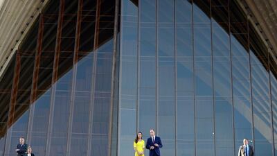 Britain’s Prince William (centre R) and his wife Catherine, the Duchess of Cambridge (centre L), are flanked by security officials at the top of the stairs of Sydney’s iconic landmark Opera House. Saeed Khan / AFP