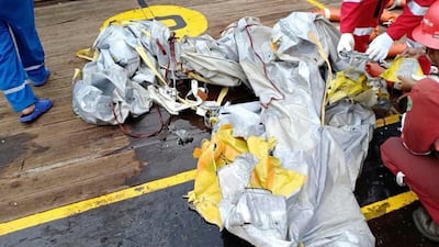 Rescuers inspect debris believed to be from the Lion Air passenger jet. AP Photo