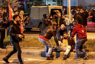 People assist a wounded protester during clashes in central Beirut, Lebanon, 14 December 2019. The sit-in continues its nightly movements in front of the parliament entrance as they refuse to assign Saad Hariri to head the government. Next 16 December parliamentary consultations will begin to choose a prime minister. Nabil Mounzer/ EPA