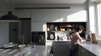 Roni Weingarten, an architect, stands in her kitchen in Oranit settlement. Rosie Scammell for The National