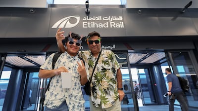 Travellers arrive at the Abu Dhabi station before embarking on one of the first passenger services