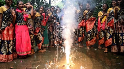 TOPSHOT - Women light firecrackers during celebrations on the eve of Diwali, the Hindu festival of lights, at the hostel of a school in Chennai on October 19, 2025. (Photo by R. Satish BABU / AFP)