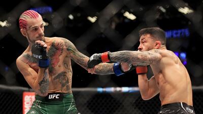 LAS VEGAS, NEVADA - JULY 02: Pedro Munhoz (R) of Brazil exchanges strikes with Sean O'Malley in their bantamweight bout during UFC 276 at T-Mobile Arena on July 02, 2022 in Las Vegas, Nevada. Carmen Mandato / Getty Images / AFP