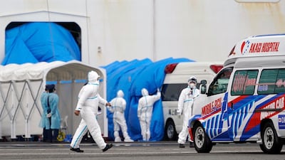 Personnel in protective gear walk towards the Diamond Princess cruise ship docked at the Daikoku Pier Cruise Terminal in Yokohama, south of Tokyo. EPA