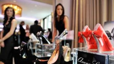 Guests look at designer shoes at the Arabian Fashion World show, which was held at the Intercontinental Hotel in West London.