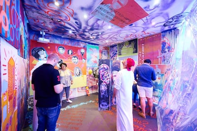 Visitors walk through Sultan Al Remeithi's 'WHERE IT BEGAN'. Warehouse421