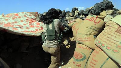 A fighter loyal to Yemen's Saudi-backed government takes position during the fight against Houthi militiamen in the northeastern province of Marib. EPA