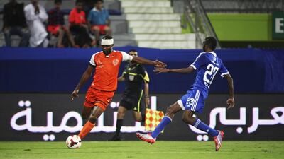 Boris Kabi, left, of Ajman crosses to a teammate during an Arabian Gulf League match against Al Nasr in Dubai on December 19, 2013. Nasr won 2-1. Lee Hoagland / The National