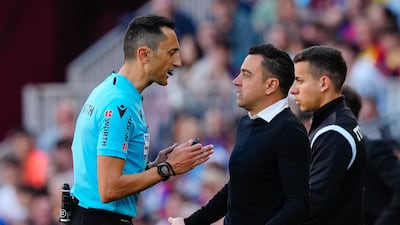 Referee Jose Maria Sanchez Martinez talks to Barcelona manager Xavi Hernandez. EPA