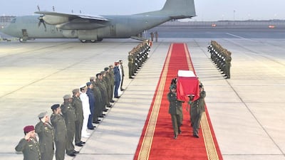 The body of Hazim Obaid Al Ali, who died in training in Saudi Arabia, is carried from the plane at Al Bateen at dawn on Wednesday. Wam