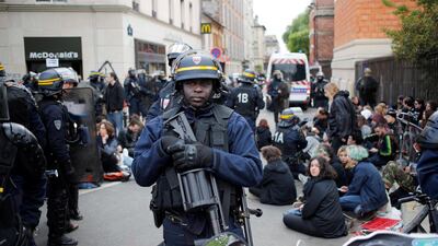Riot police detain protesters after clashes broke out with activists. AP/Francois Mori