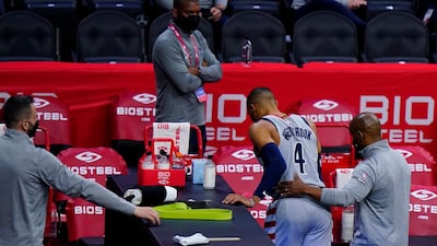 Washington Wizards' Russell Westbrook is helped to the locker room after an injury. AP