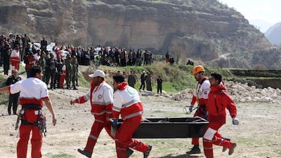 Members of the Iranian Red Crescent carry a body recovered from a wreckage of the private jet which crashed in the mountains around the city of Shahr-e Kord. Alireza Motamedi / EPA