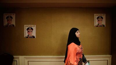 An Egyptian woman holds a petition form to nominate Defense Minister General Abdel-Fattah el-Sissi at a hotel in Cairo, Egypt. Hiro Komae / AP Photo
