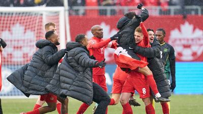 Canada players celebrate after the final whistle having sealed qualification for the 2022 World Cup. AFP