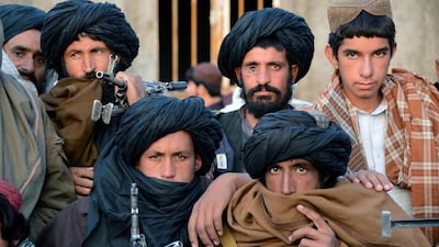 Afghan Taliban fighters look on as they listen to Mullah Mohammad Rasool Akhund (unseen), the newly appointed leader of a breakaway faction of the Taliban, at Bakwah in the western province of Farah. Javed Tanveer / AFP