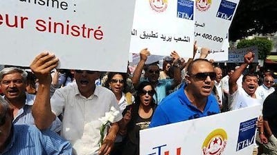 Workers in the tourism industry rally in Tunis earlier this week. The country's tourism revenue has dropped sharply after the revolution. Khalil / AFP