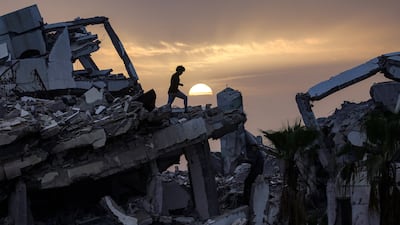 A young Palestinian man walks along the ruins of a destroyed building in the Zahra neighbourhood, south-west of Nuseirat in the central Gaza Strip. AFP